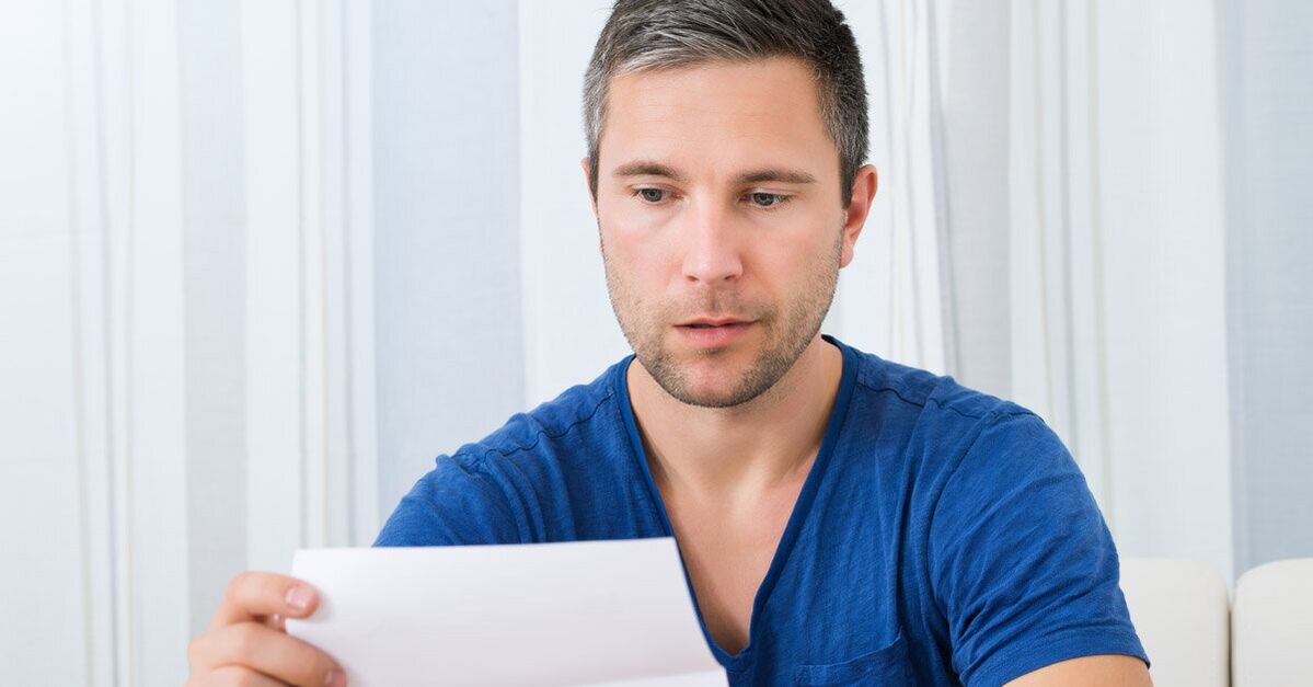 a man reads instructions for use of Predstonorm capsules